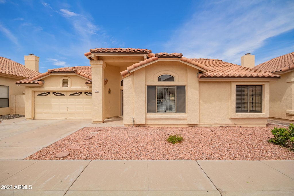 mediterranean / spanish-style home featuring a garage