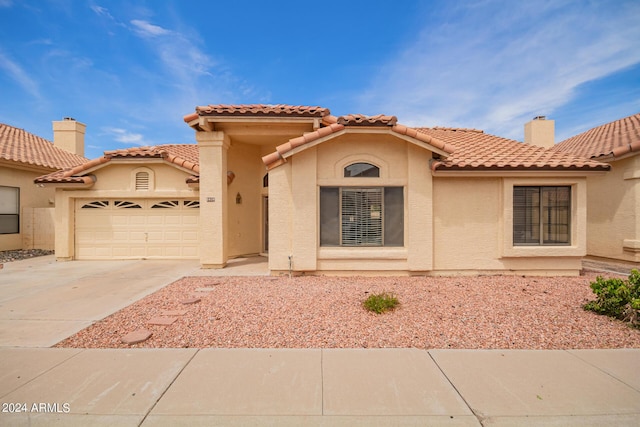 mediterranean / spanish-style home featuring a garage