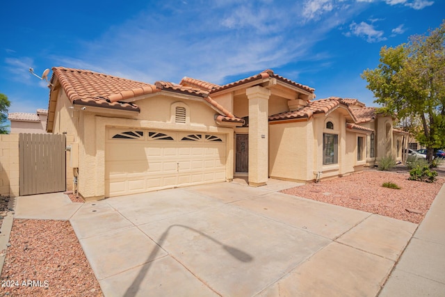 mediterranean / spanish home featuring a garage