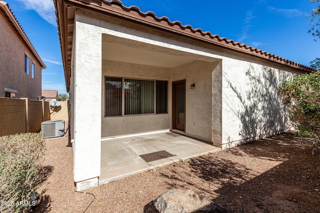 back of property featuring central AC unit and a patio area