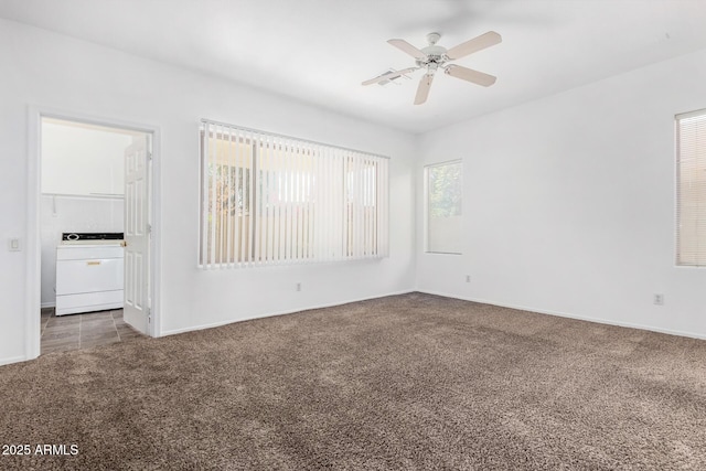 carpeted spare room featuring washer / clothes dryer and ceiling fan