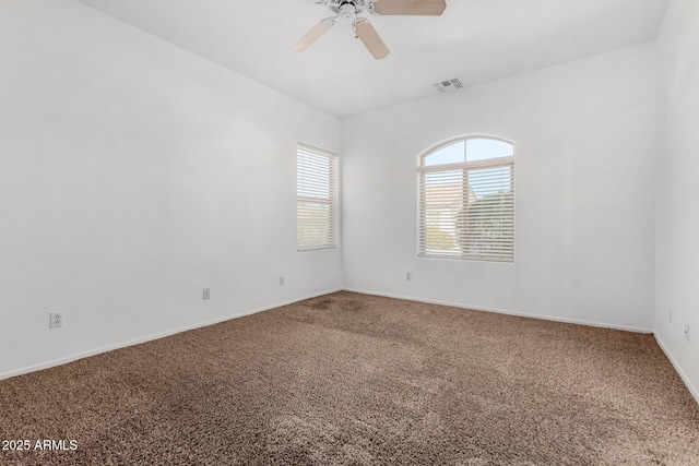 empty room with carpet floors and ceiling fan