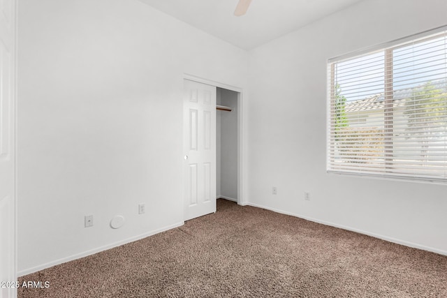 unfurnished bedroom with carpet floors, a closet, and ceiling fan