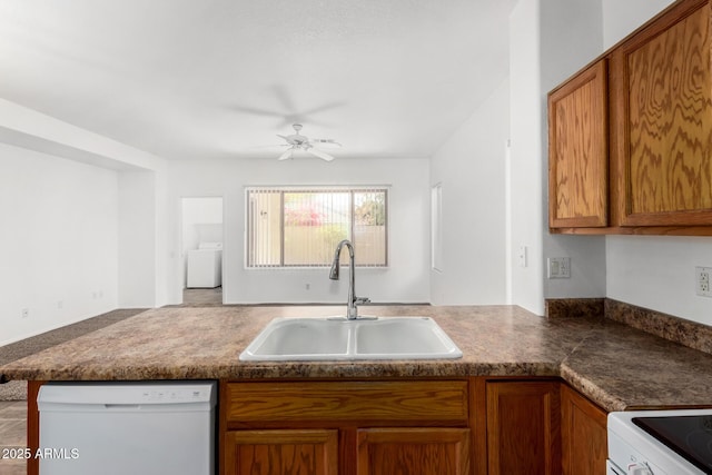 kitchen featuring sink, dishwasher, kitchen peninsula, ceiling fan, and washer / clothes dryer