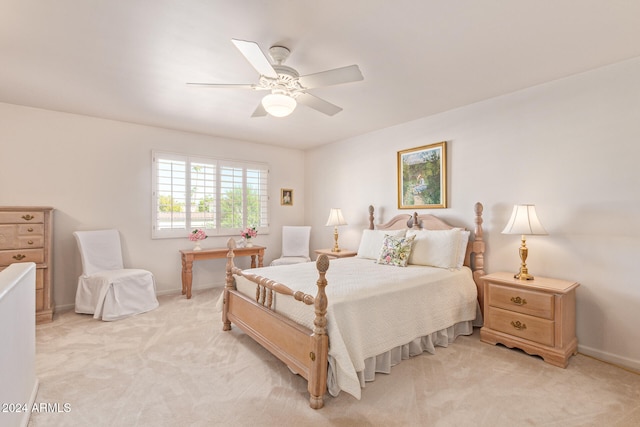 bedroom featuring light carpet and ceiling fan