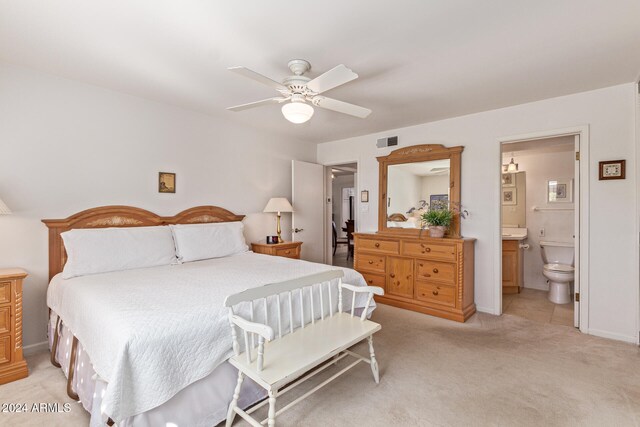 carpeted bedroom with connected bathroom and ceiling fan