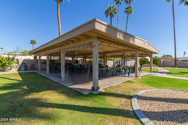 view of property's community featuring a patio and a lawn