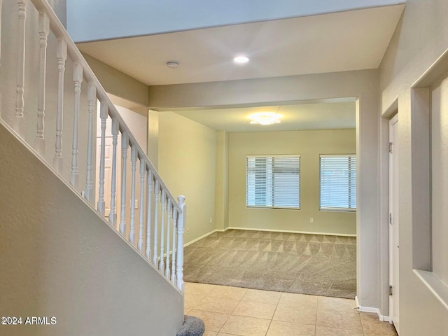 entrance foyer featuring light colored carpet