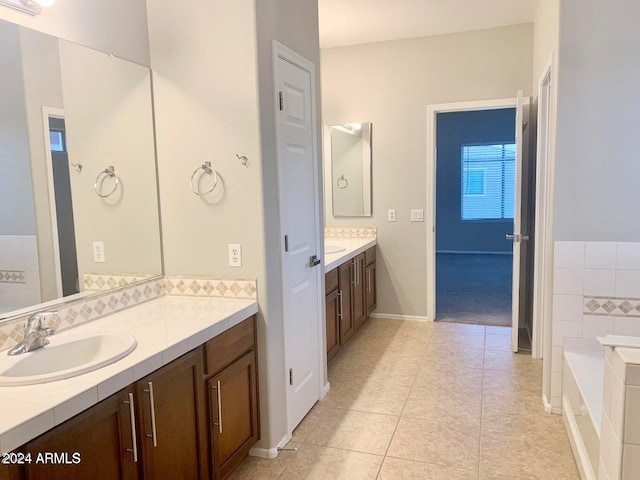 bathroom with vanity, a bathtub, and tile patterned floors