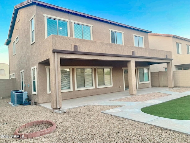 rear view of property featuring a patio area and cooling unit