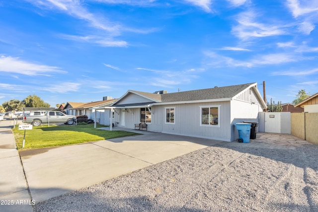 ranch-style house with a patio and a front lawn