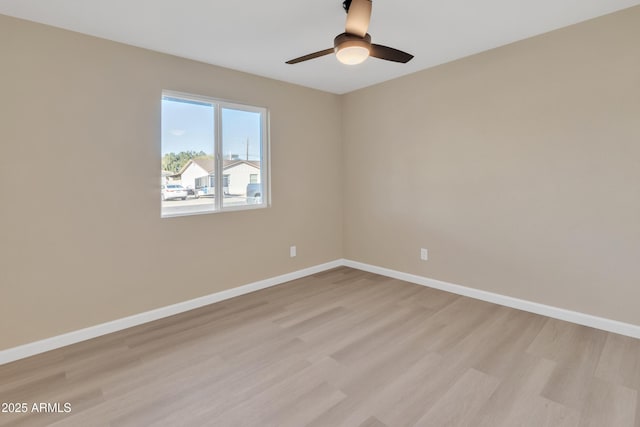 empty room featuring ceiling fan and light hardwood / wood-style floors