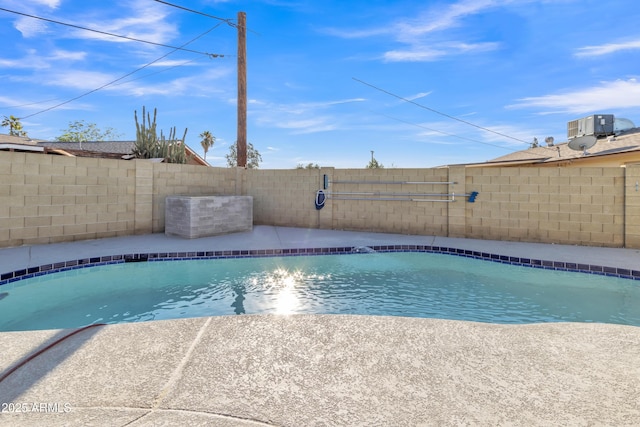 view of swimming pool featuring central AC unit