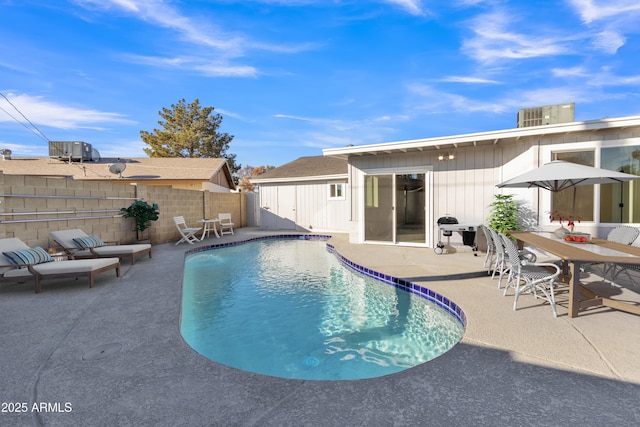 view of swimming pool featuring central air condition unit and a patio