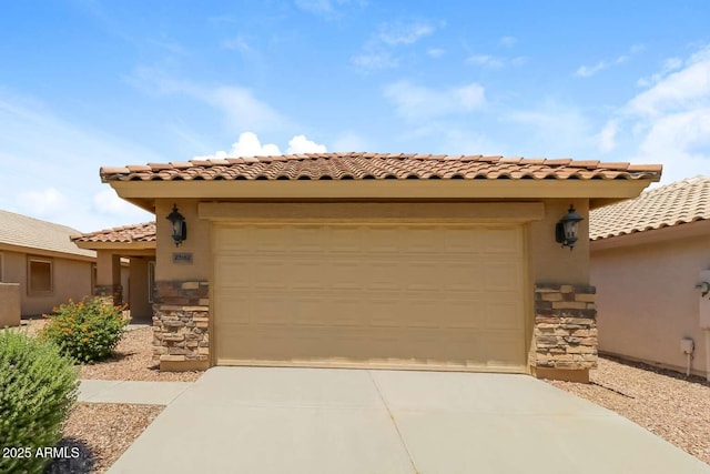 23162 W Lasso Ln, Buckeye, AZ 85326 - mediterranean / spanish house featuring concrete driveway, stone siding, an attached garage, a tiled roof, and stucco siding