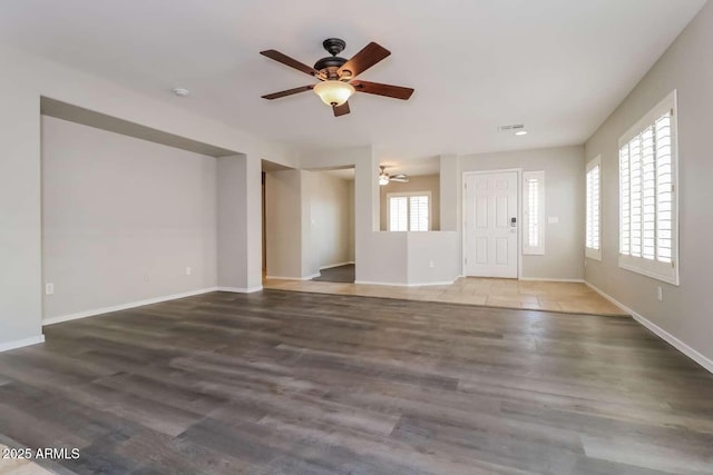 23162 W Lasso Ln, Buckeye, AZ 85326 - unfurnished living room featuring ceiling fan, wood finished floors, and baseboards