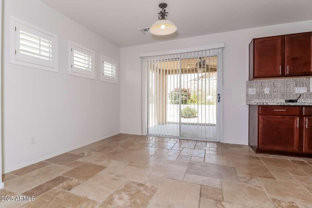 23162 W Lasso Ln, Buckeye, AZ 85326 - unfurnished dining area with stone tile floors