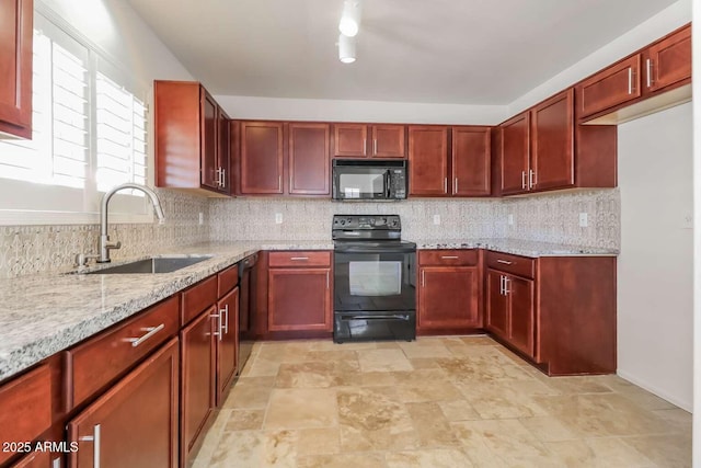 23162 W Lasso Ln, Buckeye, AZ 85326 - kitchen featuring black appliances, a sink, dark brown cabinets, and light stone counters