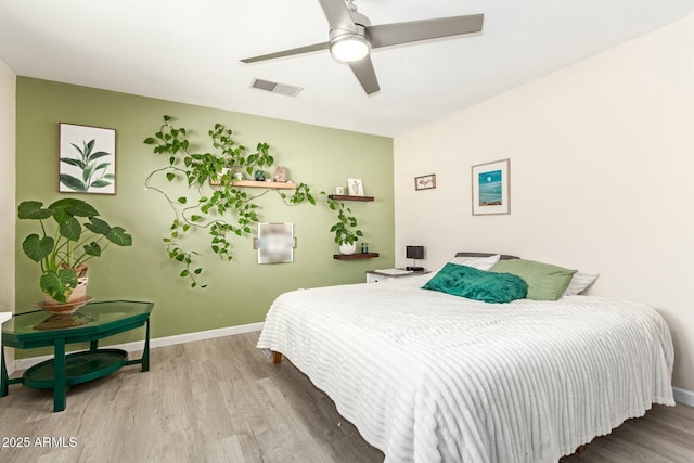 bedroom with ceiling fan and light hardwood / wood-style floors