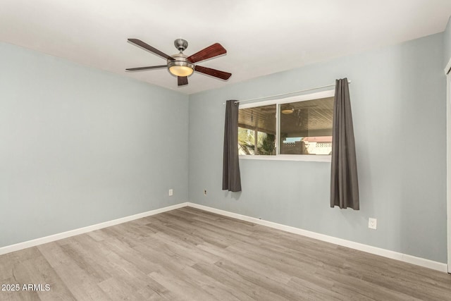 empty room with ceiling fan and light hardwood / wood-style flooring