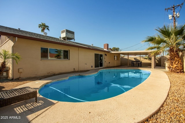 view of swimming pool featuring a patio and cooling unit