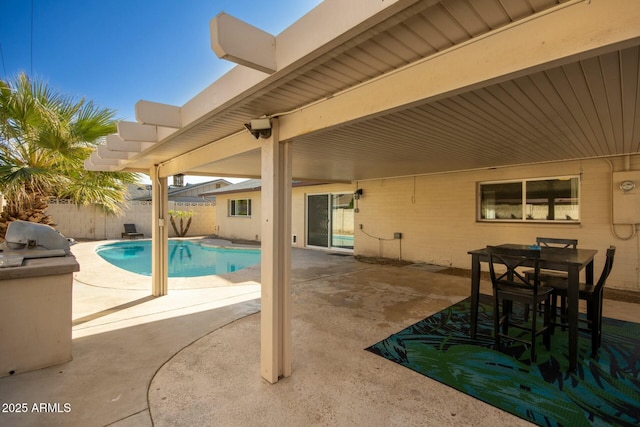 view of patio / terrace with a fenced in pool and an outdoor kitchen