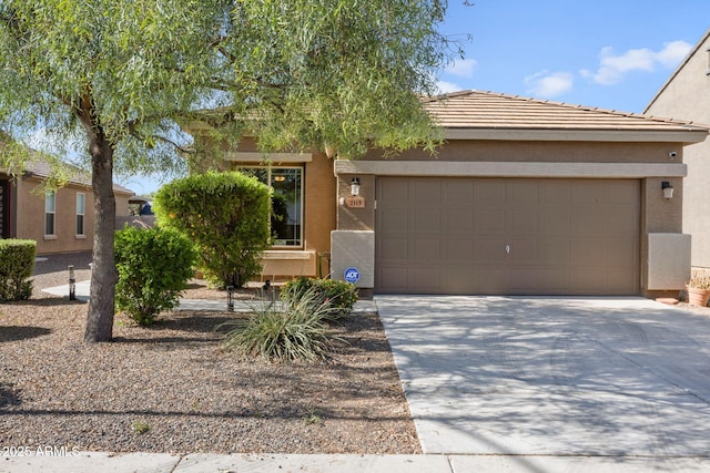 2119 E Phelps Rd, Phoenix, AZ 85022 - obstructed view of property featuring stucco siding, concrete driveway, an attached garage, and a tiled roof
