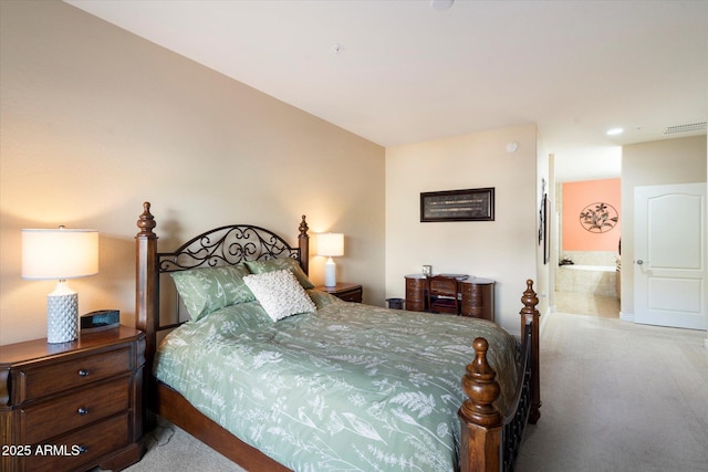 carpeted bedroom featuring ensuite bath