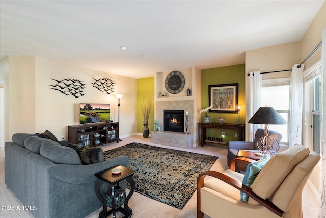 carpeted living room with a premium fireplace