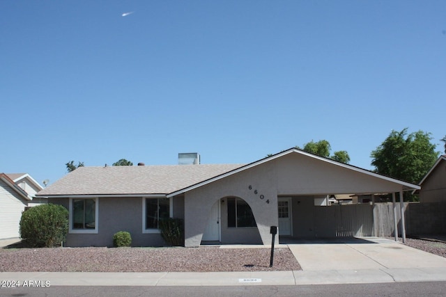 ranch-style home with a carport