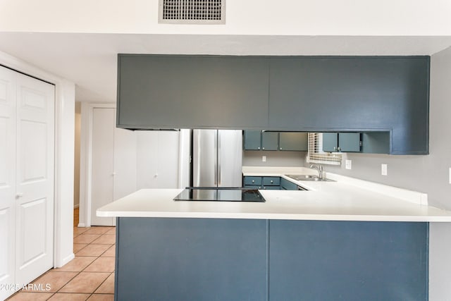 kitchen featuring black electric stovetop, kitchen peninsula, and sink