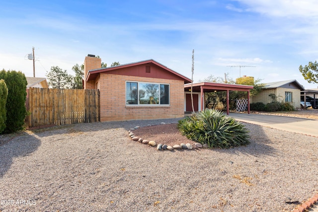 ranch-style house featuring a carport