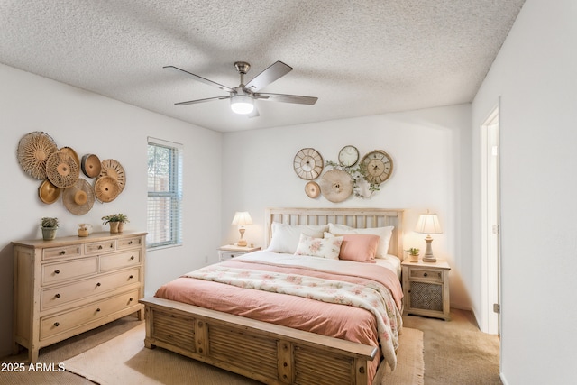 carpeted bedroom featuring ceiling fan and a textured ceiling