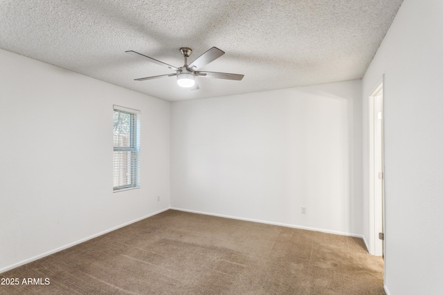 unfurnished room with a textured ceiling, ceiling fan, and carpet