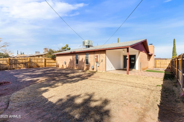 rear view of property with a patio area and central air condition unit