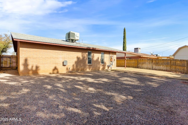 rear view of property featuring central AC