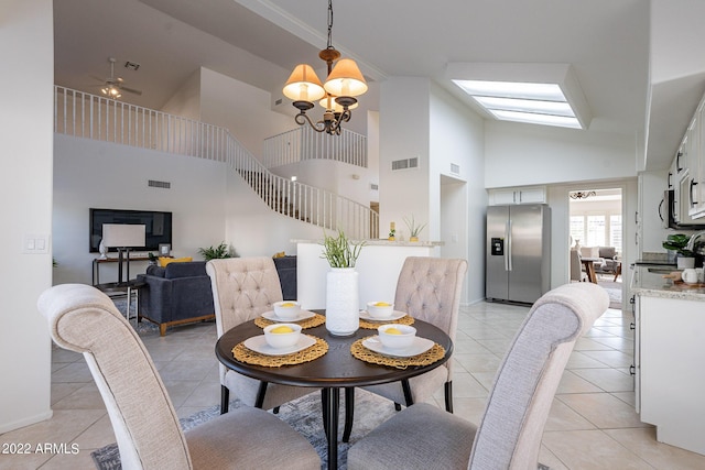 dining area featuring light tile patterned floors, visible vents, a notable chandelier, and stairs