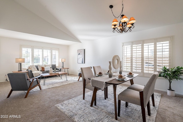 dining area featuring light carpet, a notable chandelier, baseboards, and vaulted ceiling