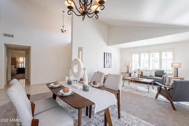 dining room featuring a notable chandelier, light tile patterned flooring, visible vents, and high vaulted ceiling