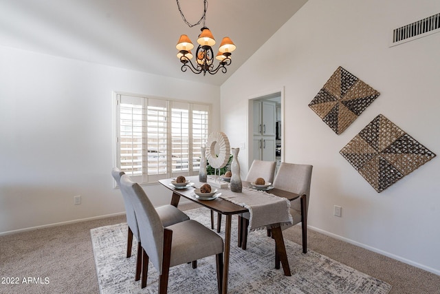 carpeted dining area with an inviting chandelier, baseboards, visible vents, and lofted ceiling