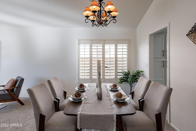 carpeted dining room with a notable chandelier