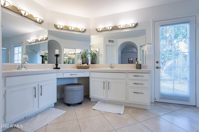 bathroom with tile patterned floors, double vanity, visible vents, and a sink