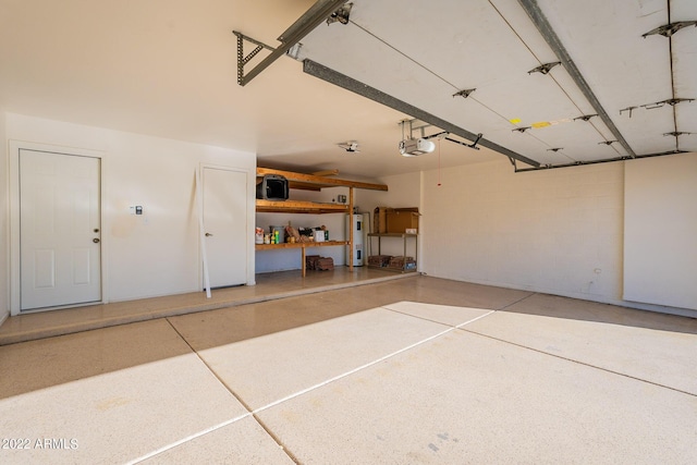 garage with water heater and a garage door opener