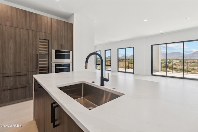 19355 N 73rd Way Unit E-4014, Scottsdale, AZ 85255 - kitchen with modern cabinets, light stone counters, open floor plan, recessed lighting, and double oven