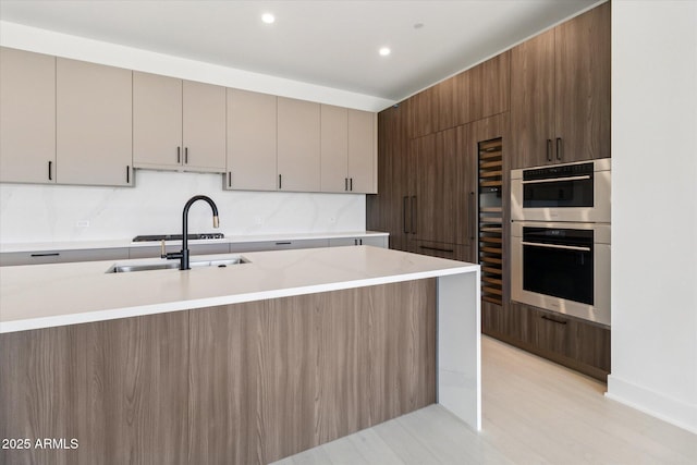 19355 N 73rd Way Unit E-4014, Scottsdale, AZ 85255 - kitchen featuring stainless steel double oven, modern cabinets, recessed lighting, light wood-style floors, and decorative backsplash