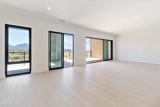 19355 N 73rd Way Unit E-4014, Scottsdale, AZ 85255 - empty room with light wood finished floors, recessed lighting, and a mountain view