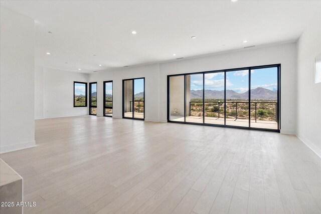 19355 N 73rd Way Unit E-4014, Scottsdale, AZ 85255 - spare room featuring plenty of natural light, recessed lighting, light wood-type flooring, and a mountain view