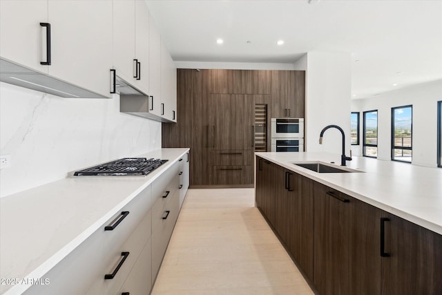19355 N 73rd Way Unit E-4014, Scottsdale, AZ 85255 - kitchen with stainless steel gas cooktop, light countertops, modern cabinets, recessed lighting, and light wood-style flooring