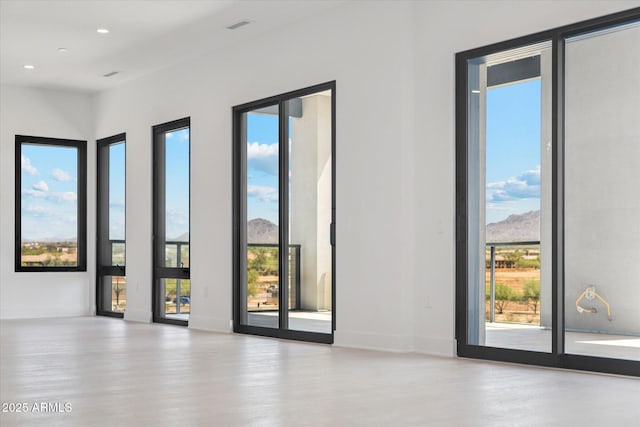 19355 N 73rd Way Unit E-4014, Scottsdale, AZ 85255 - spare room with wood finished floors, plenty of natural light, a mountain view, and recessed lighting