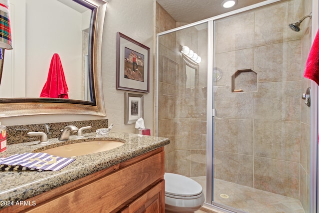 bathroom featuring vanity, toilet, and walk in shower